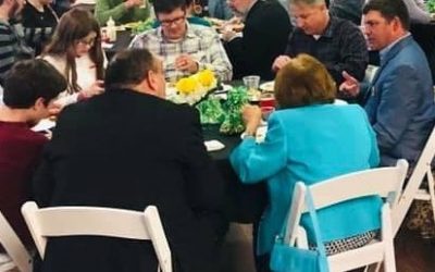 people sitting around a dinner table