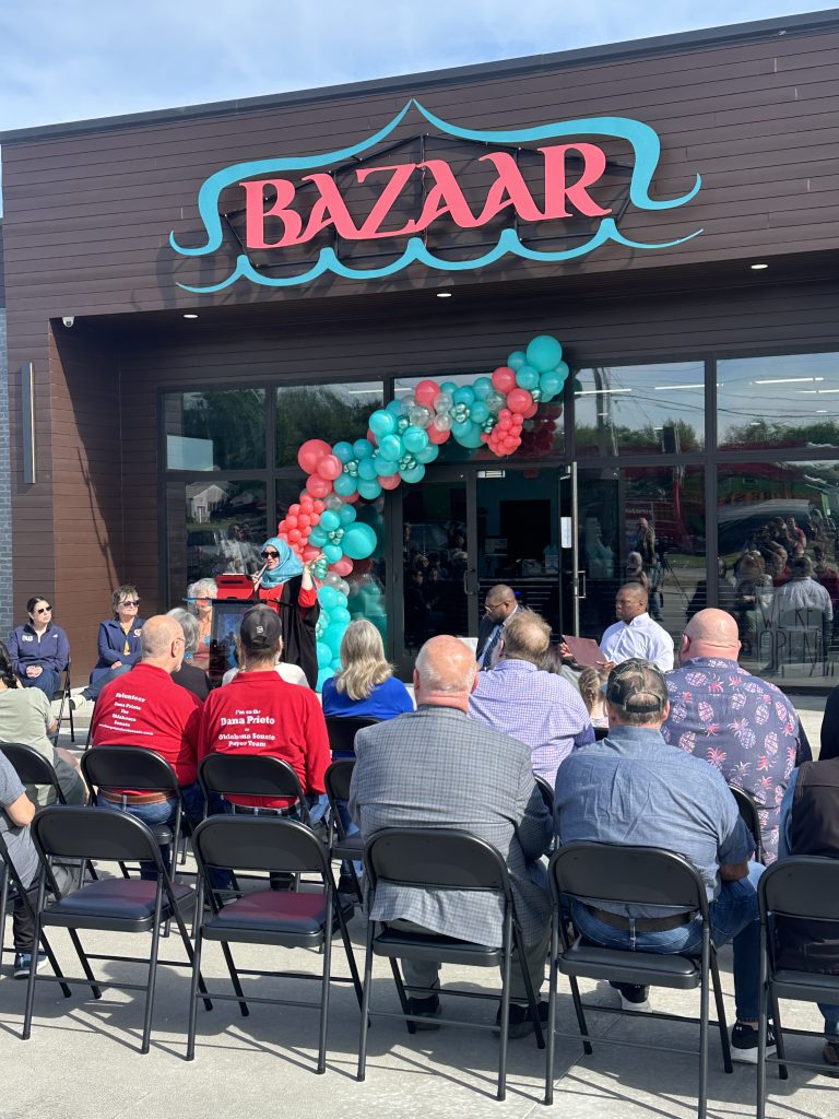 Bazaar grocery store Grand Opening audience and our CEO Aliye speaking